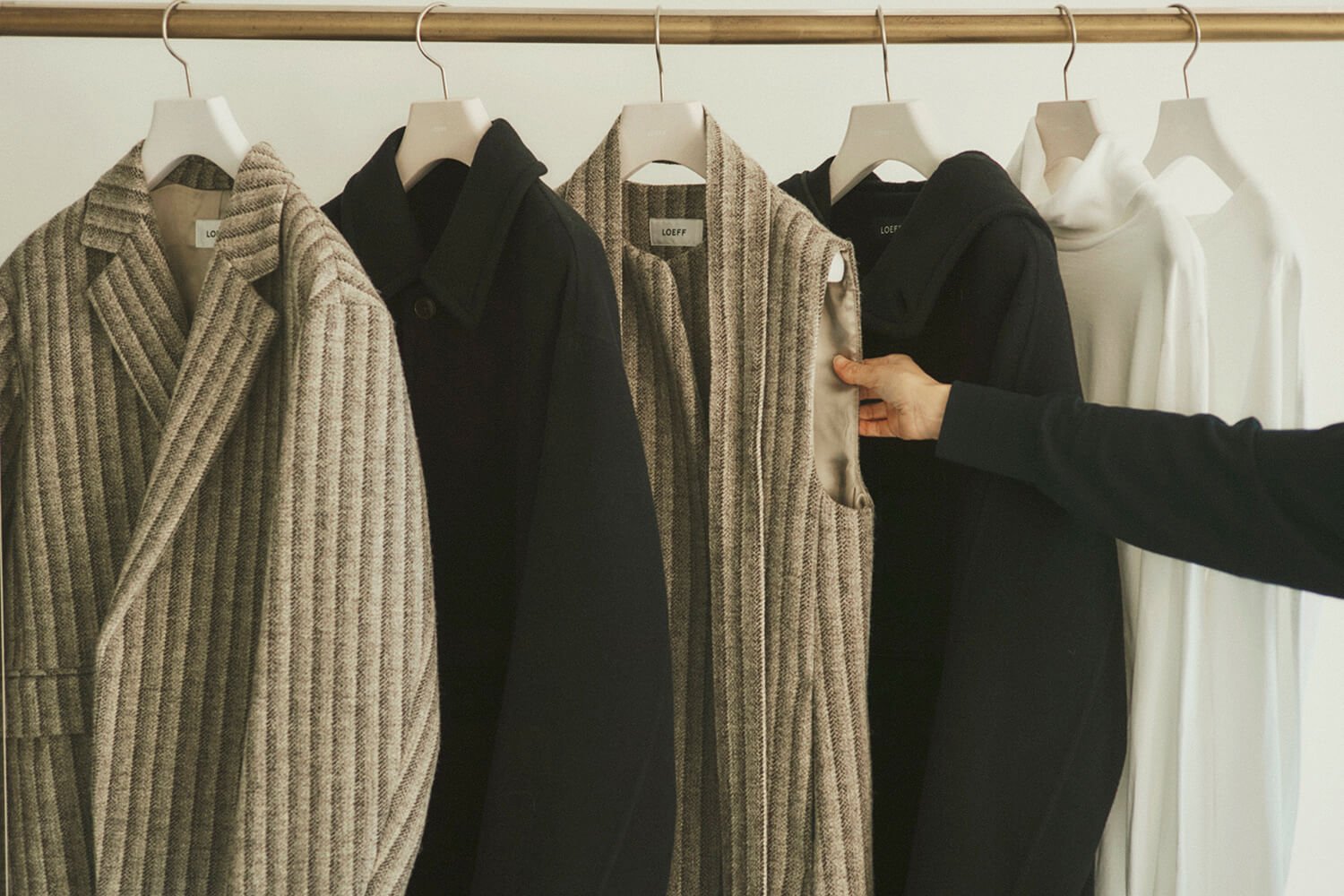 A closeup of the Loeff clothing collection, showing the rich textures of sustainable fabrics used in their blazers and vests.